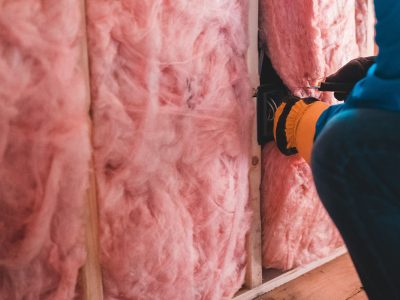 Walkers Insulation installation pink bats in a wall.